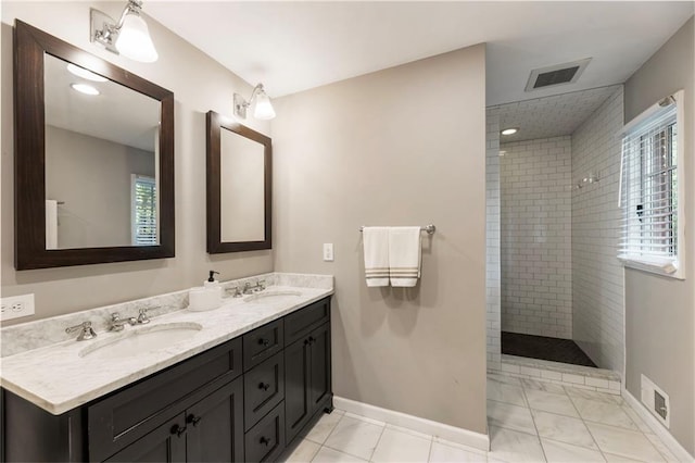 full bathroom with a walk in shower, baseboards, double vanity, and marble finish floors