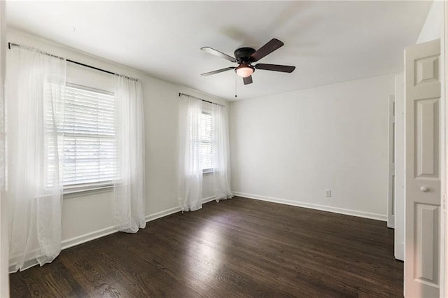 unfurnished room with a ceiling fan, dark wood-style flooring, and baseboards