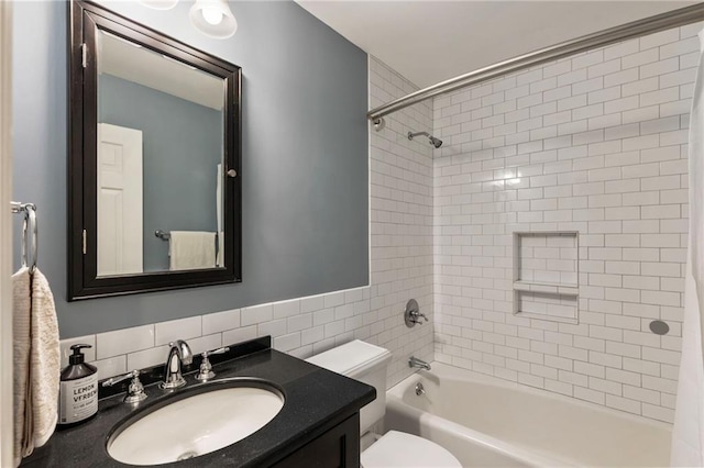 bathroom featuring toilet, vanity, and shower / bathtub combination