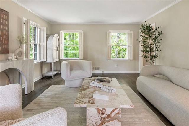 living area featuring crown molding, wood finished floors, and baseboards