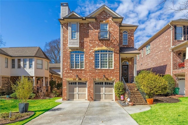 view of front of home with an attached garage, brick siding, driveway, a front lawn, and a chimney