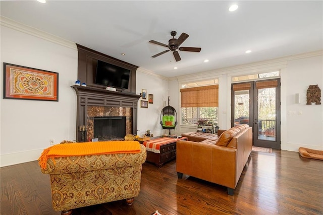 living room with dark wood-style floors, french doors, a fireplace, recessed lighting, and ornamental molding