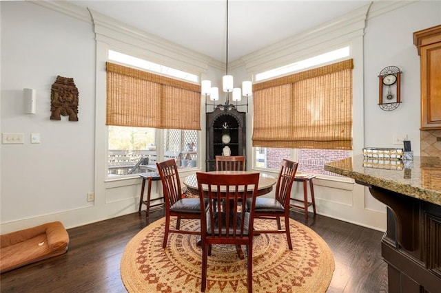 dining area with ornamental molding and dark wood finished floors