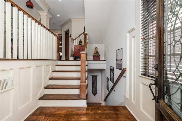 entrance foyer with crown molding, stairs, and dark wood-type flooring