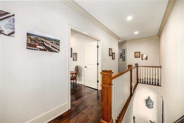 corridor with baseboards, dark wood finished floors, ornamental molding, an upstairs landing, and recessed lighting