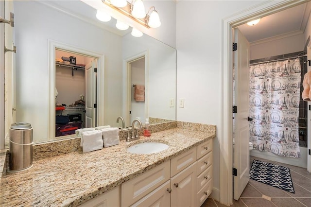 full bath with a shower with curtain, vanity, and tile patterned floors