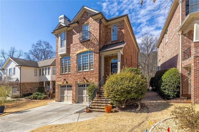 view of front of home featuring concrete driveway, brick siding, a chimney, and an attached garage