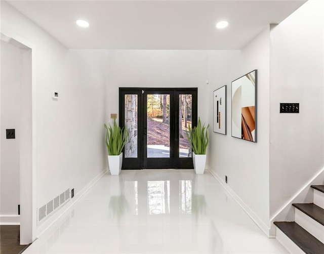 tiled foyer featuring french doors