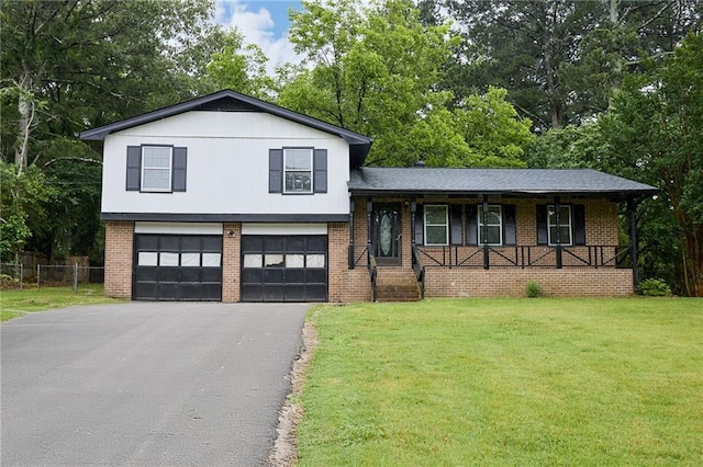 382 Plantation Blvd, Lawrenceville, GA 30046 - tri-level home with driveway, a garage, covered porch, and brick siding