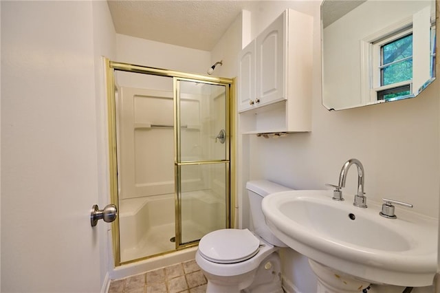 382 Plantation Blvd, Lawrenceville, GA 30046 - bathroom with a stall shower, a sink, toilet, a textured ceiling, and baseboards