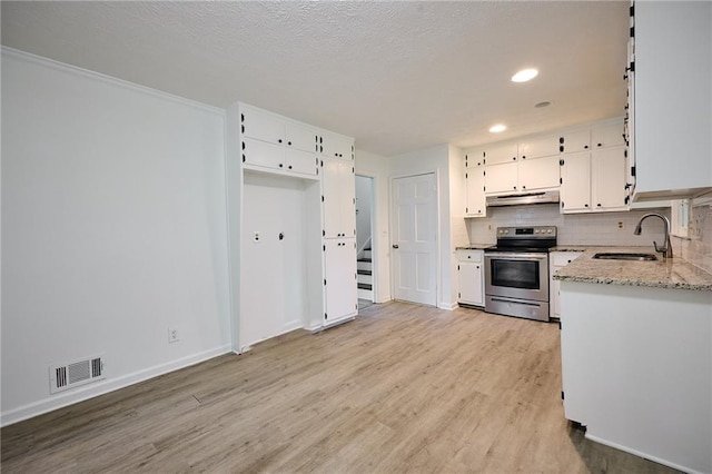 382 Plantation Blvd, Lawrenceville, GA 30046 - kitchen with stainless steel range with electric stovetop, a sink, under cabinet range hood, light wood-style floors, and white cabinets