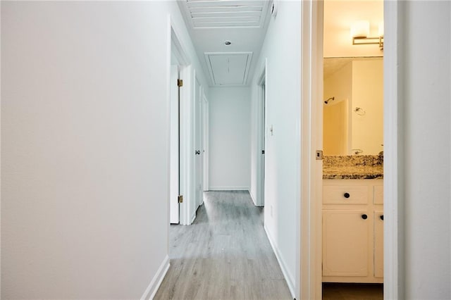 382 Plantation Blvd, Lawrenceville, GA 30046 - hallway with attic access, light wood-type flooring, and baseboards