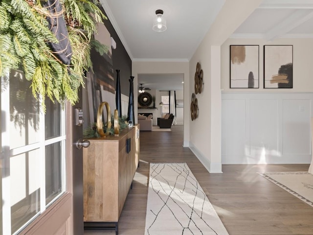 hallway with hardwood / wood-style flooring and ornamental molding