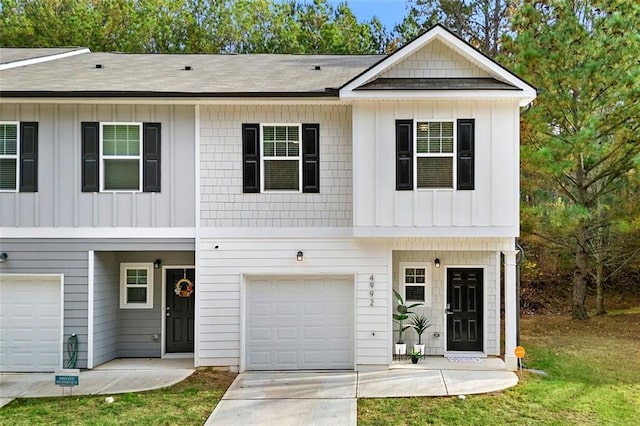 4992 Lower Elm St, Atlanta, GA 30349 - view of front of home featuring board and batten siding, a garage, and driveway