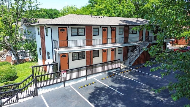 692 Smith St SW, Atlanta, GA 30310 - view of front of property featuring stairway, uncovered parking, a shingled roof, and a balcony