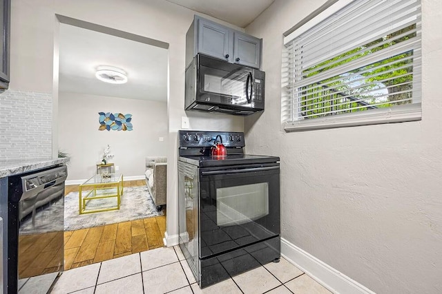 692 Smith St SW, Atlanta, GA 30310 - kitchen with black appliances and light tile patterned floors
