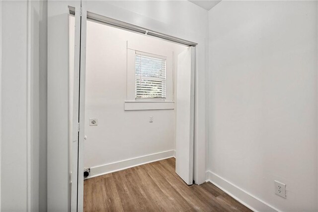 clothes washing area featuring hardwood / wood-style flooring