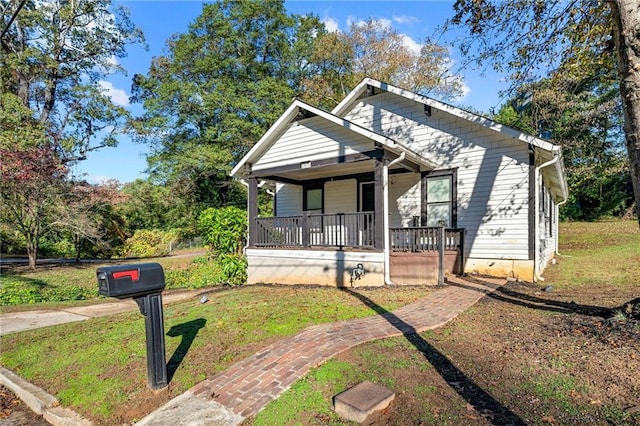 bungalow-style home with a front lawn and a porch