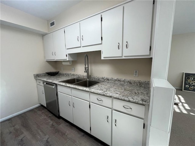 kitchen featuring a sink, visible vents, light countertops, stainless steel dishwasher, and dark wood finished floors