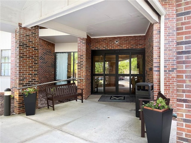 entrance to property featuring brick siding