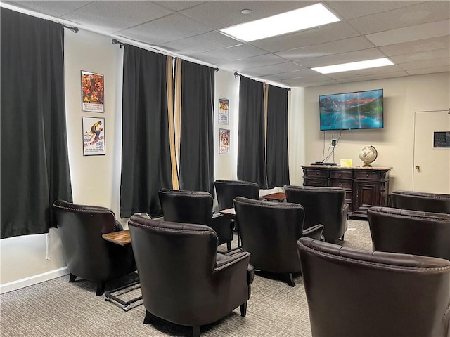 home theater with a paneled ceiling and light colored carpet