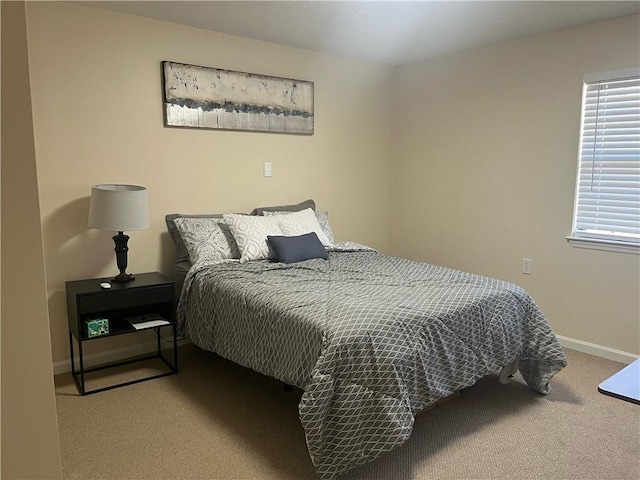 carpeted bedroom with baseboards