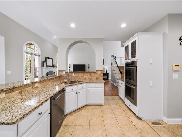 1630 Reindeer Rdg, Alpharetta, GA 30005 - kitchen with appliances with stainless steel finishes, white cabinets, glass insert cabinets, tasteful backsplash, and light stone counters