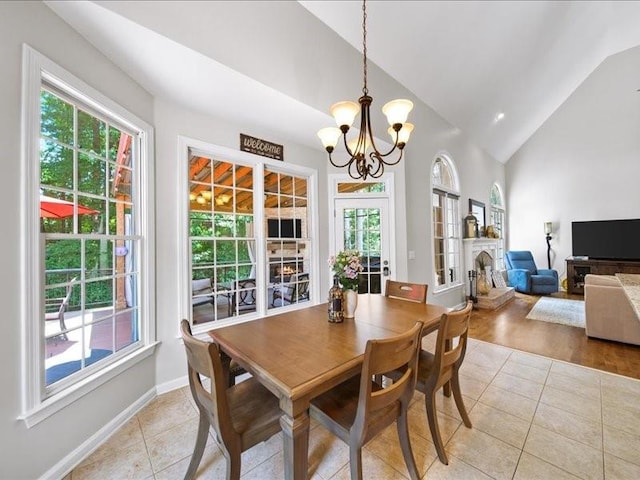 1630 Reindeer Rdg, Alpharetta, GA 30005 - dining area with light tile patterned floors, plenty of natural light, a chandelier, and high vaulted ceiling
