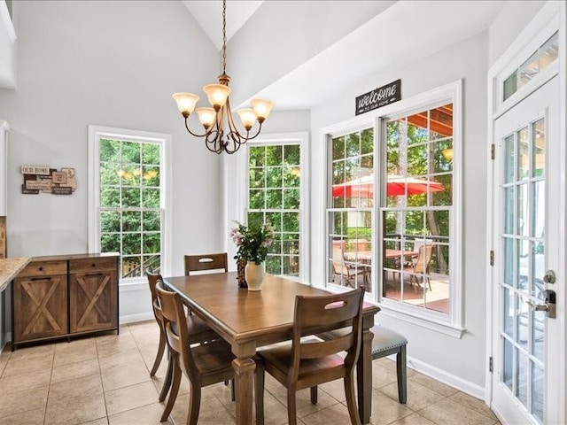 1630 Reindeer Rdg, Alpharetta, GA 30005 - dining space with light tile patterned floors, a chandelier, healthy amount of natural light, and vaulted ceiling