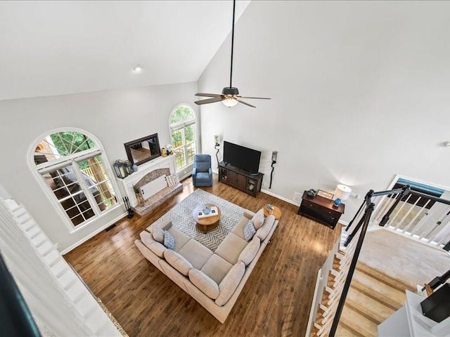 1630 Reindeer Rdg, Alpharetta, GA 30005 - living area with a fireplace with raised hearth, high vaulted ceiling, wood finished floors, and a ceiling fan