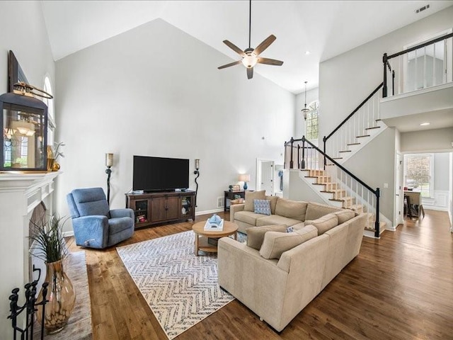 1630 Reindeer Rdg, Alpharetta, GA 30005 - living area with high vaulted ceiling, wood finished floors, stairs, ceiling fan, and a fireplace with raised hearth