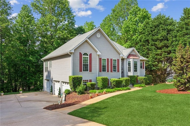 view of front of property featuring a garage, concrete driveway, and a front lawn