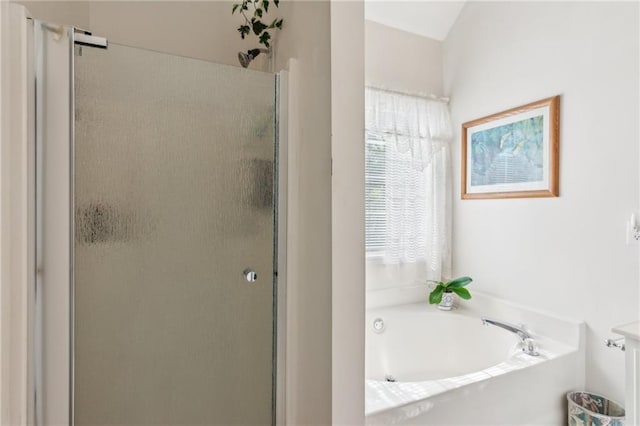 bathroom with a bath and a stall shower