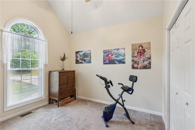workout room with visible vents, carpet, baseboards, and vaulted ceiling