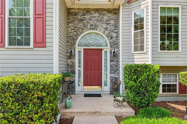 view of exterior entry featuring stone siding