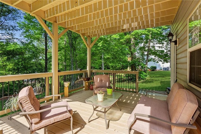wooden terrace with an outdoor living space