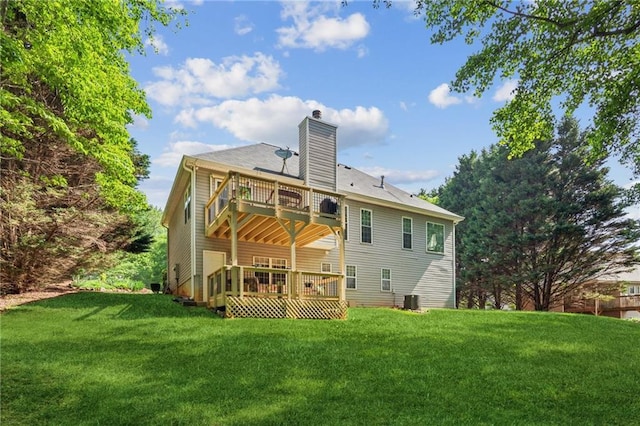 rear view of house with a chimney, a lawn, a deck, central AC, and a balcony
