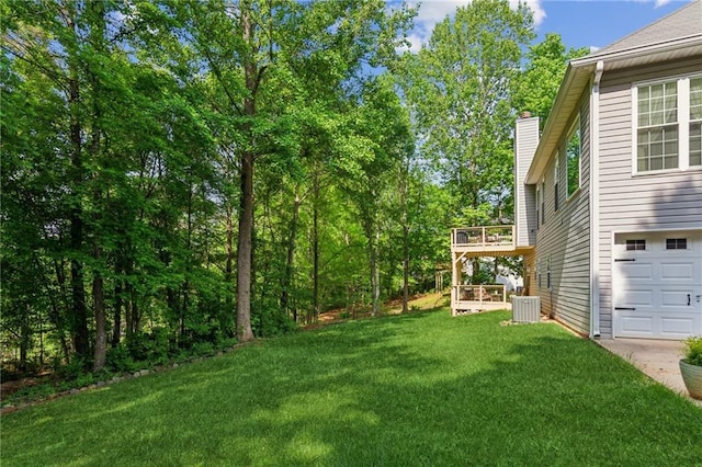 view of yard featuring central AC unit and a deck