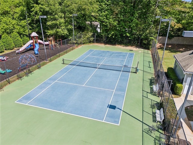 view of tennis court with fence and playground community