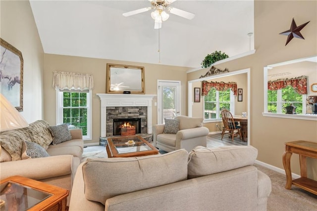 carpeted living area featuring baseboards, ceiling fan, high vaulted ceiling, and a fireplace