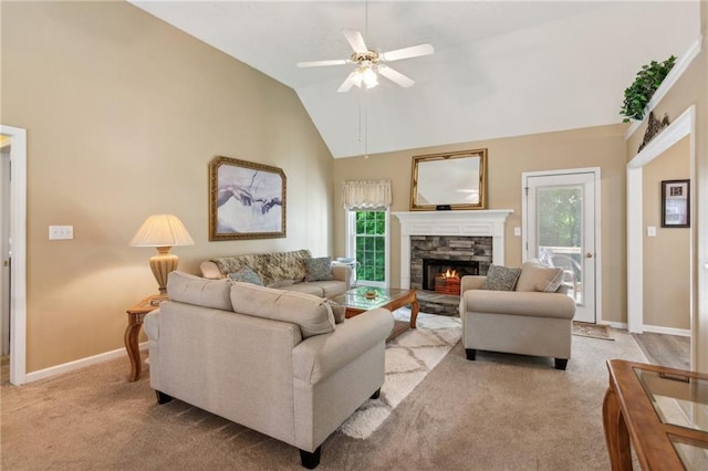 living room with plenty of natural light, baseboards, ceiling fan, and a fireplace