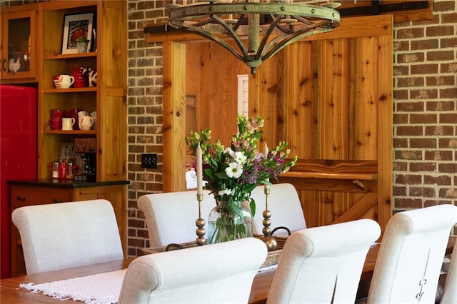 dining space with brick wall