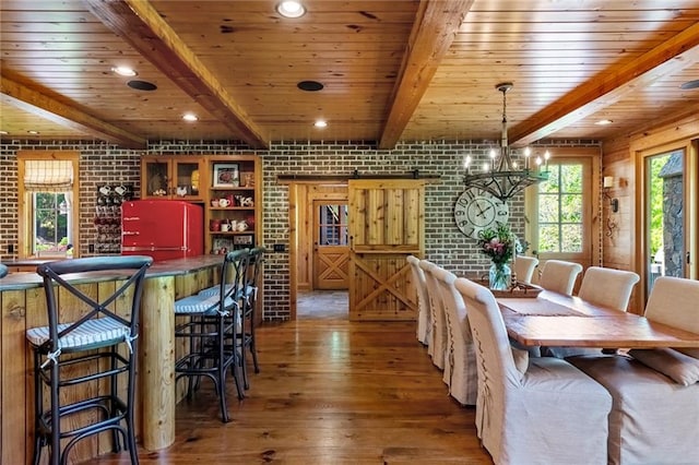 dining space featuring beam ceiling, wood ceiling, and brick wall