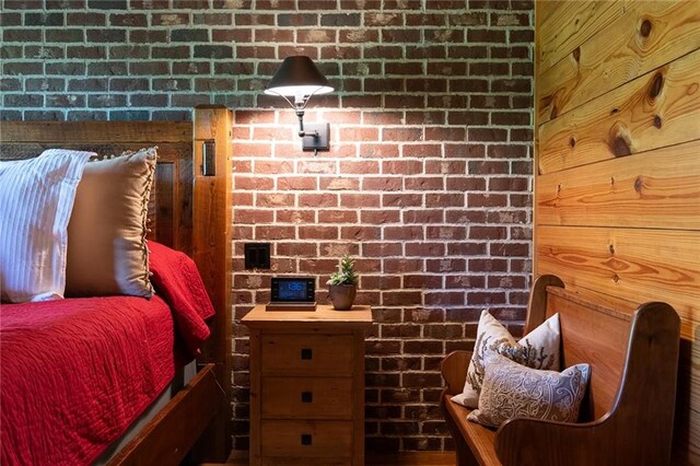 bedroom with brick wall and wood walls