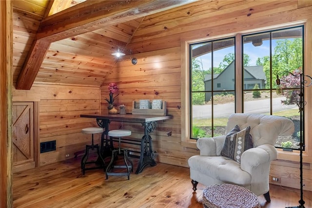 office space with wooden ceiling, lofted ceiling, wood walls, and light hardwood / wood-style flooring