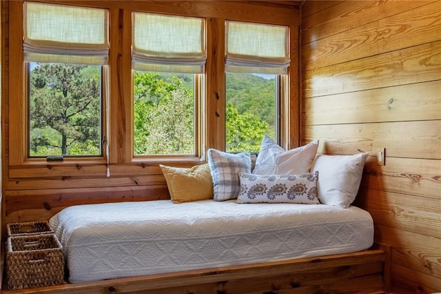 bedroom featuring wooden walls