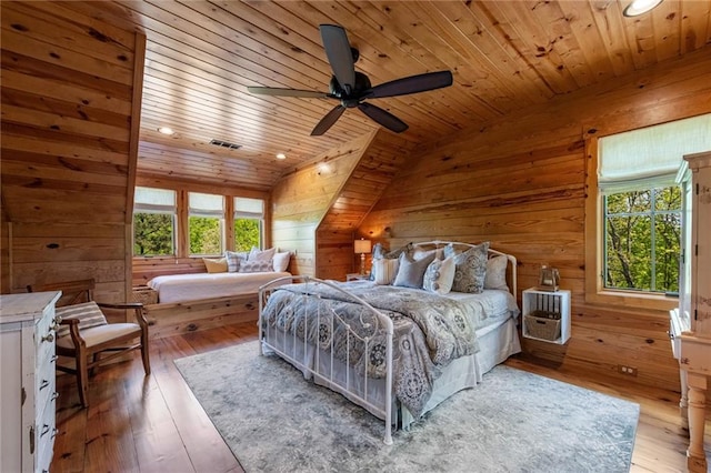 bedroom featuring wooden ceiling, hardwood / wood-style flooring, multiple windows, and vaulted ceiling