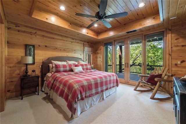 carpeted bedroom with ceiling fan, a tray ceiling, french doors, access to outside, and wooden ceiling