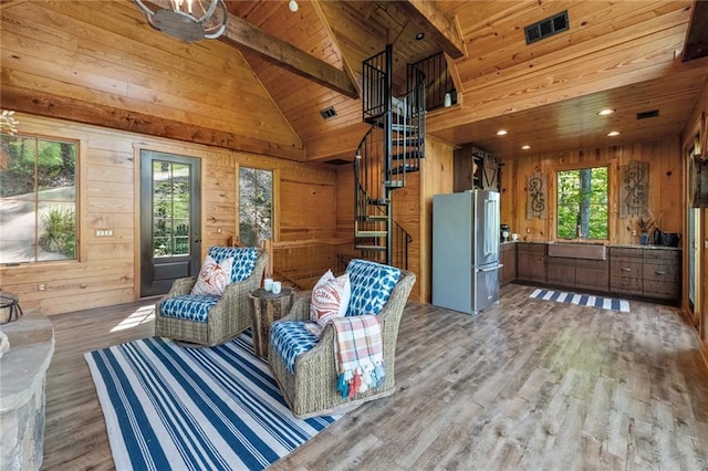 interior space featuring beamed ceiling, wooden ceiling, wooden walls, wood-type flooring, and high vaulted ceiling