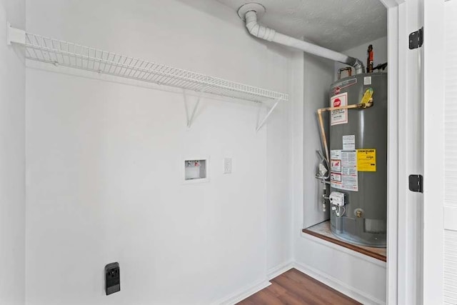 laundry area with dark wood finished floors, water heater, laundry area, hookup for a washing machine, and electric dryer hookup